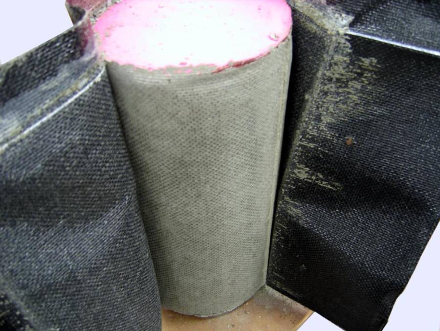 Figure 24: Stripping fabric from a fabric formed concrete cylinder.